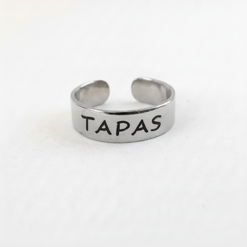 Silver ring with 'Tapas' engraved on a white background